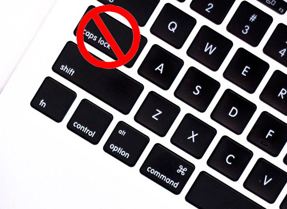 A close up of a keyboard with a red circle around the caps lock key