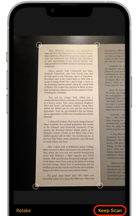 A cell phone is scanning a page of a book
