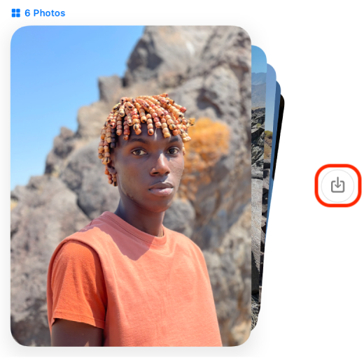 A man with dreadlocks is standing in front of a mountain