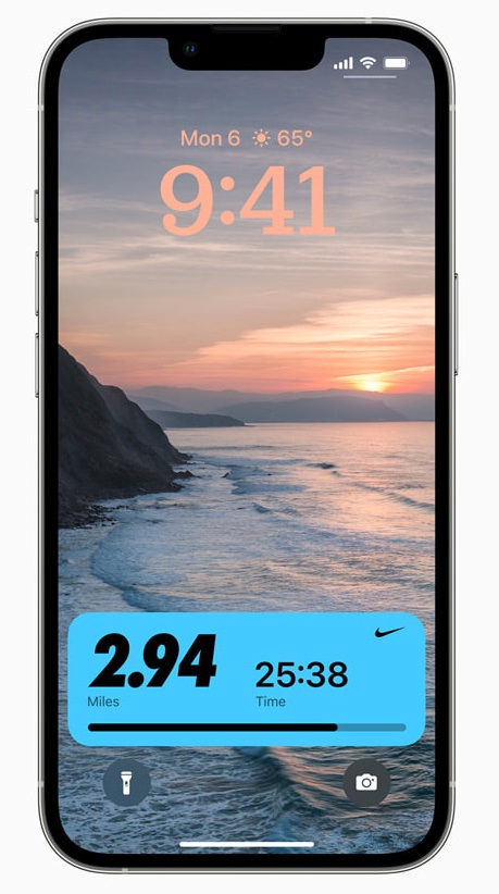 A cell phone with a picture of a beach on the screen.