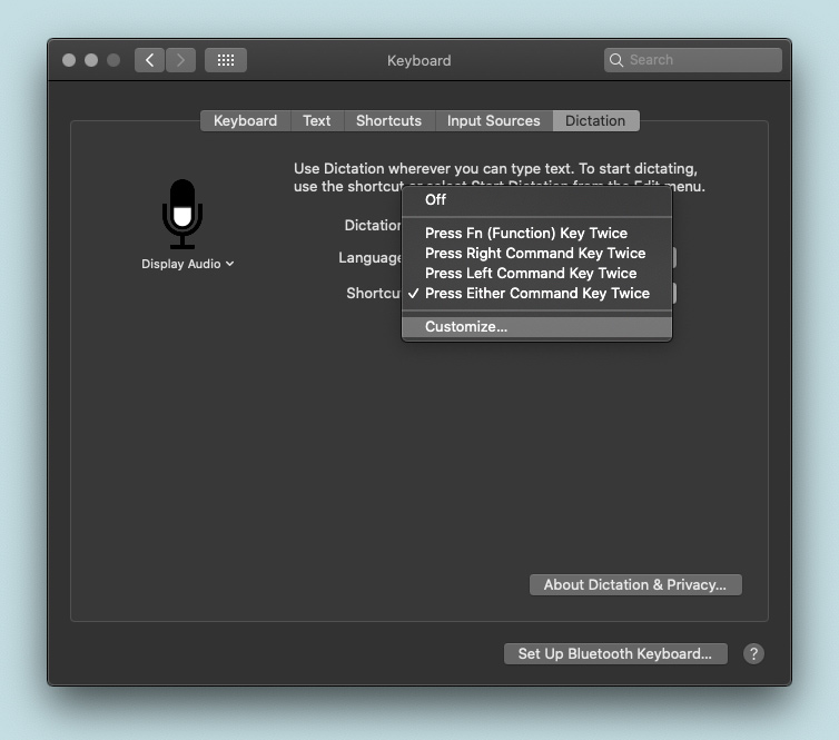 A computer screen with a microphone on it