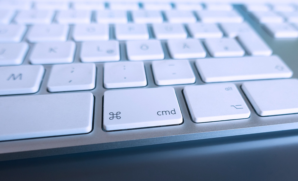 A close up of a keyboard with the cmd key visible