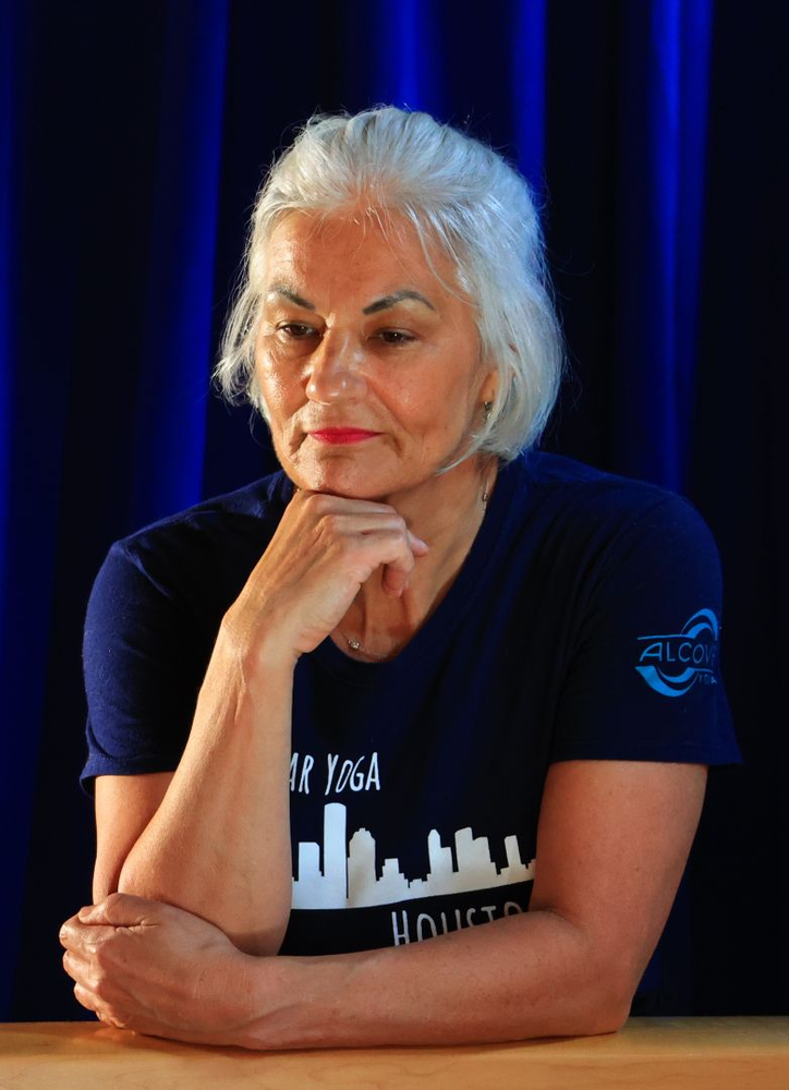 A woman wearing a blue shirt with the word houston on it