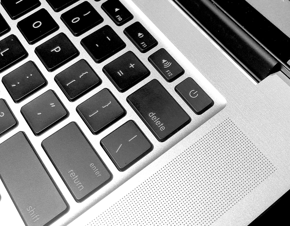 A close up of the delete key on a laptop