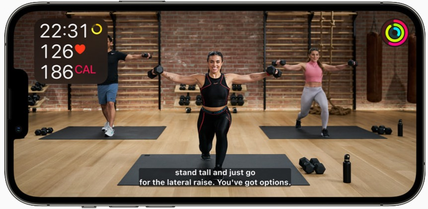A group of people are doing exercises in a gym on a cell phone.