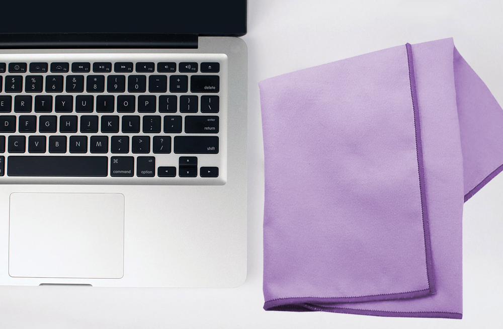 A laptop with a purple cloth next to it