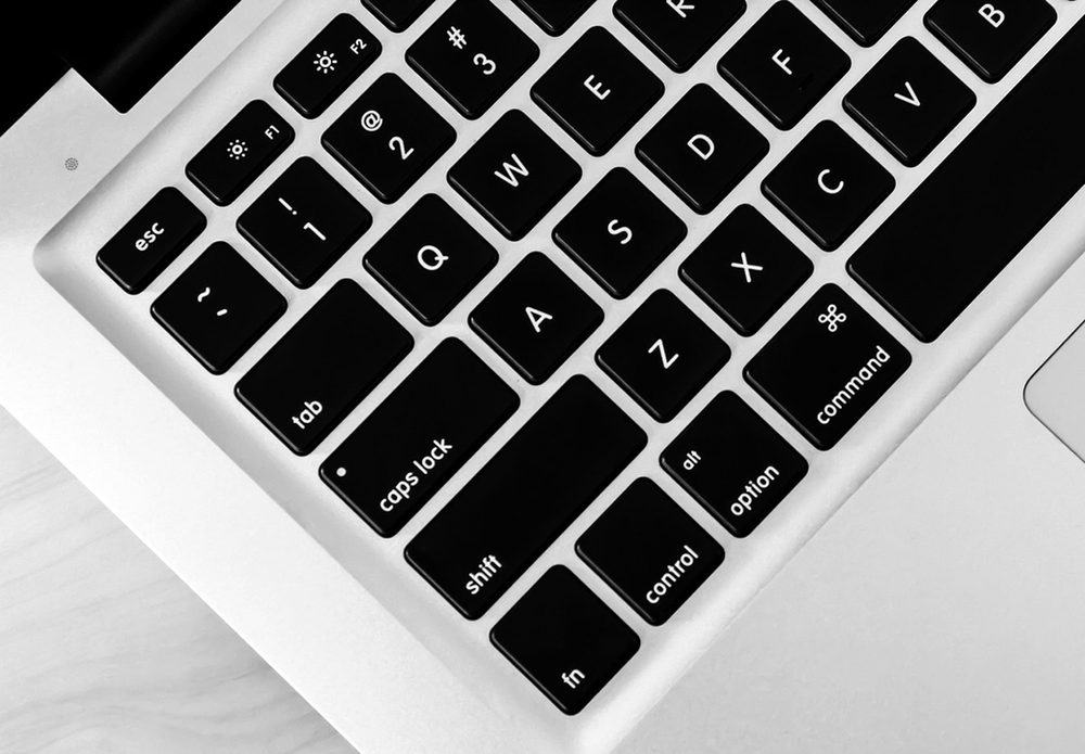 A close up of a laptop keyboard with the esc key visible