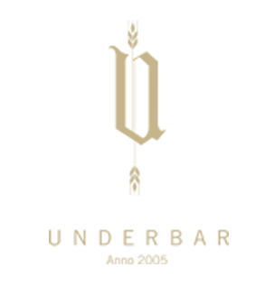 Logo for Underbar. En stilisert gullfarget «U» med hvetedetaljer og teksten «UNDERBAR Anno 2005».