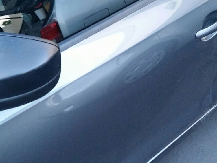 A close up of a car door with a side mirror