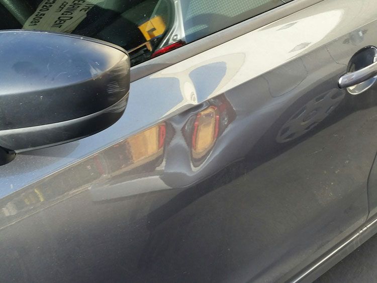 A close up of the side of a car with a sticker on the windshield that says jeep