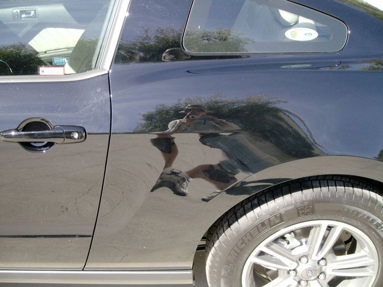 A black car with a tire that says continental on it