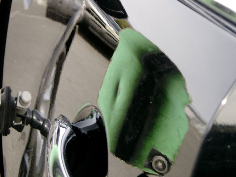 A close up of a green object on a car