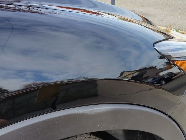 A close up of the hood of a black car