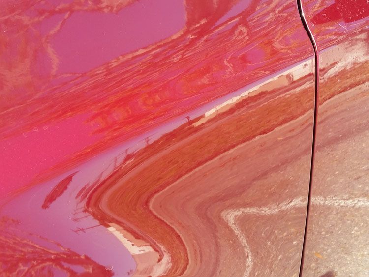 A close up of the side of a red car