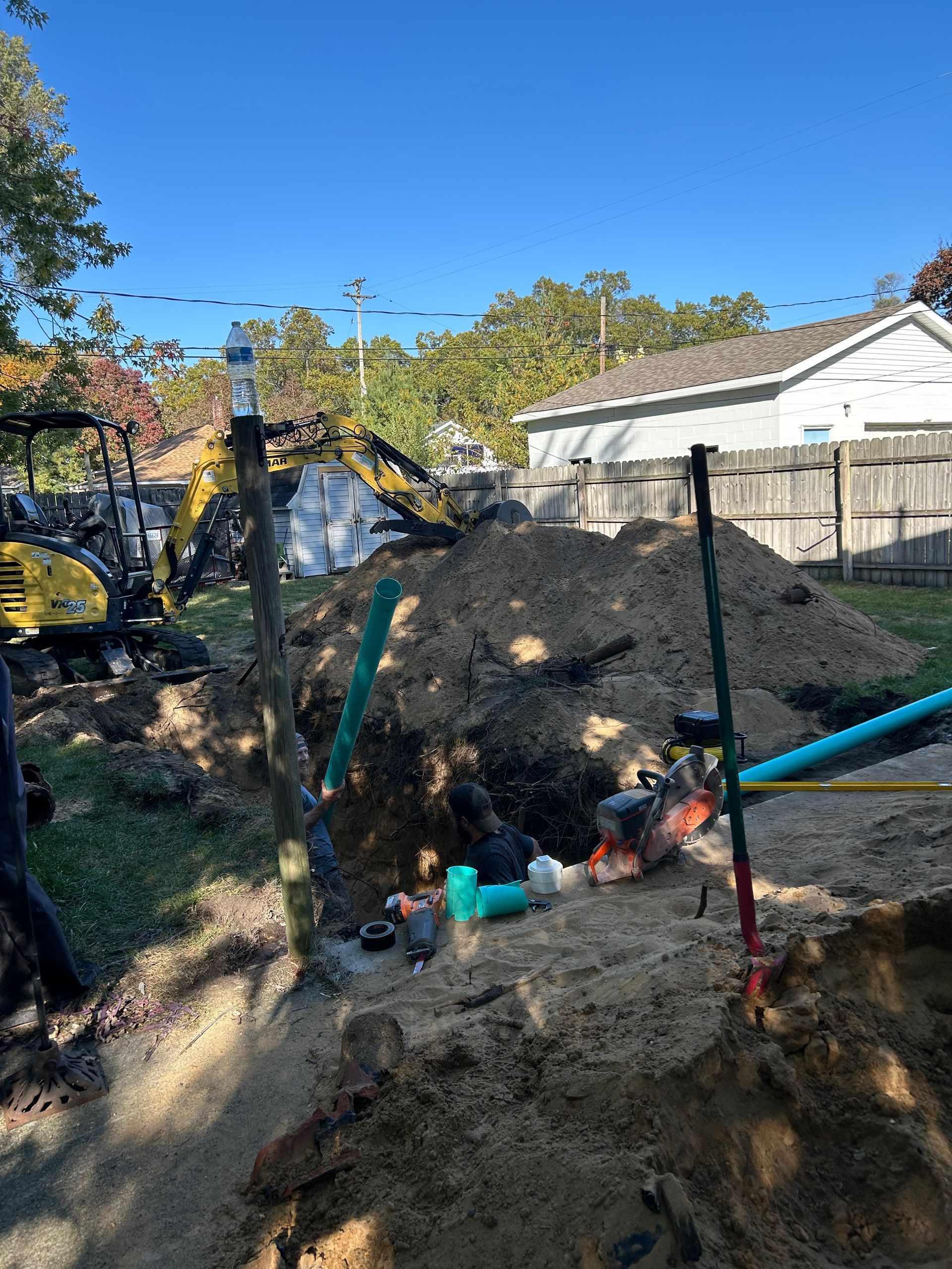 A large pile of dirt is sitting in front of a house.
