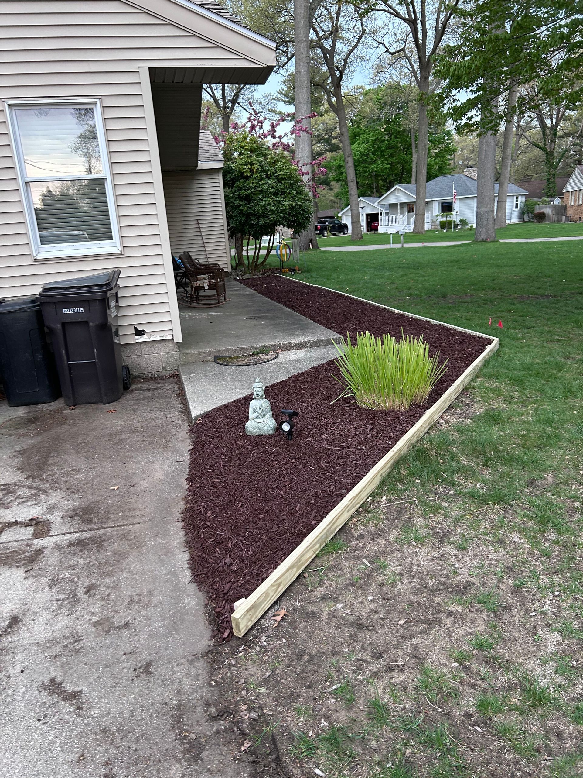A house with a garden in front of it.