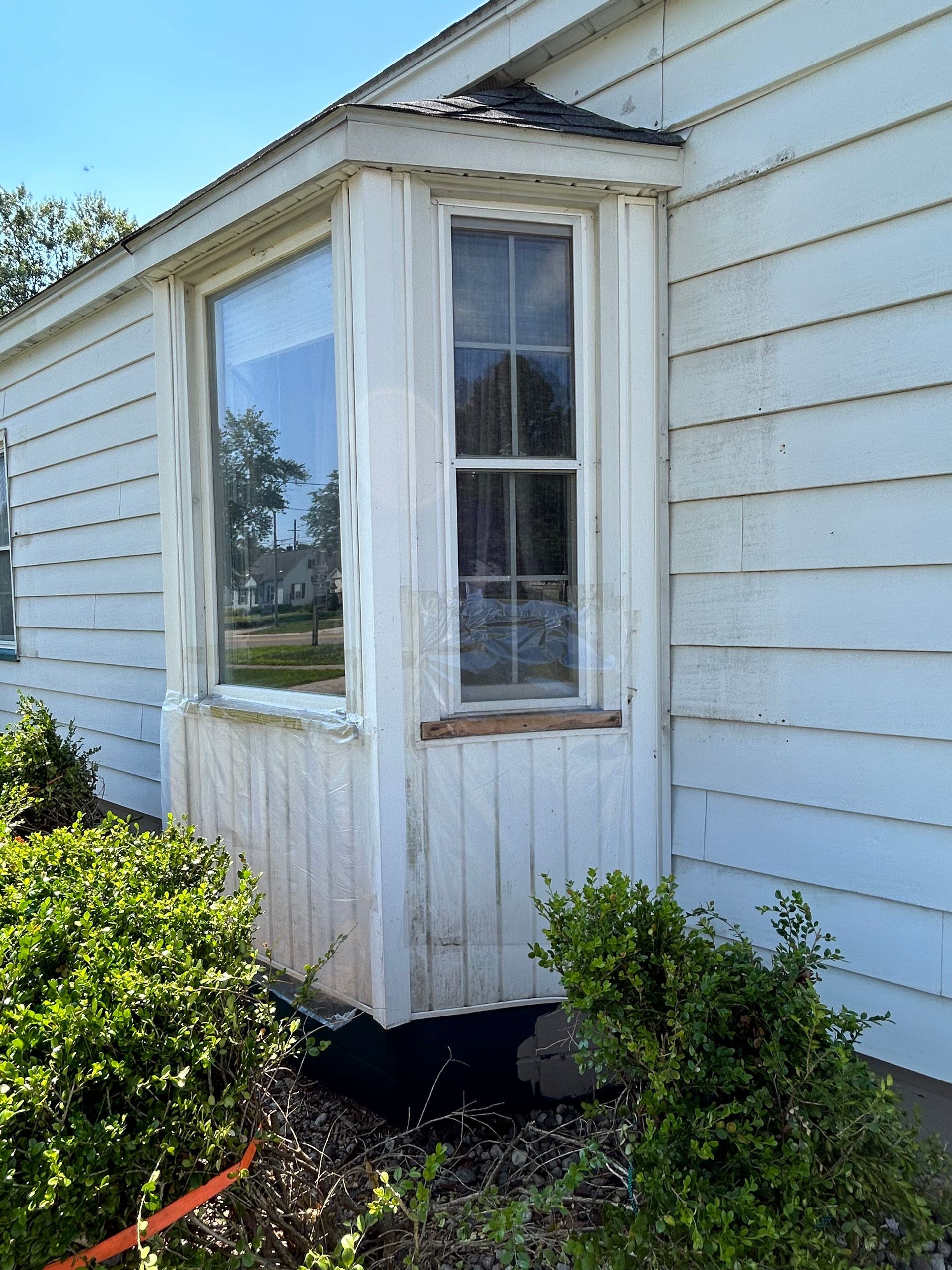 A white house with a window on the side of it