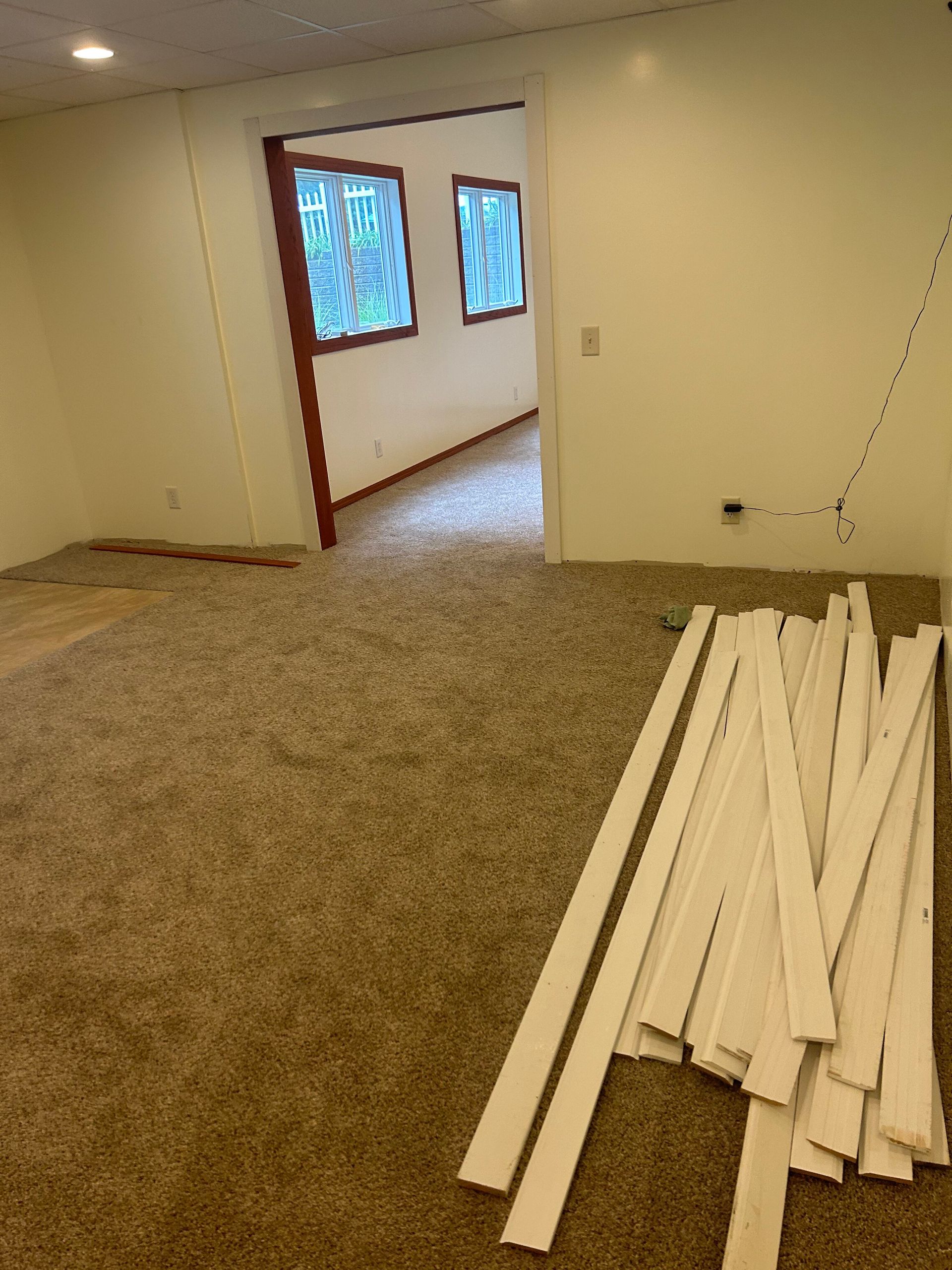A room with a lot of white pieces of wood on the floor.