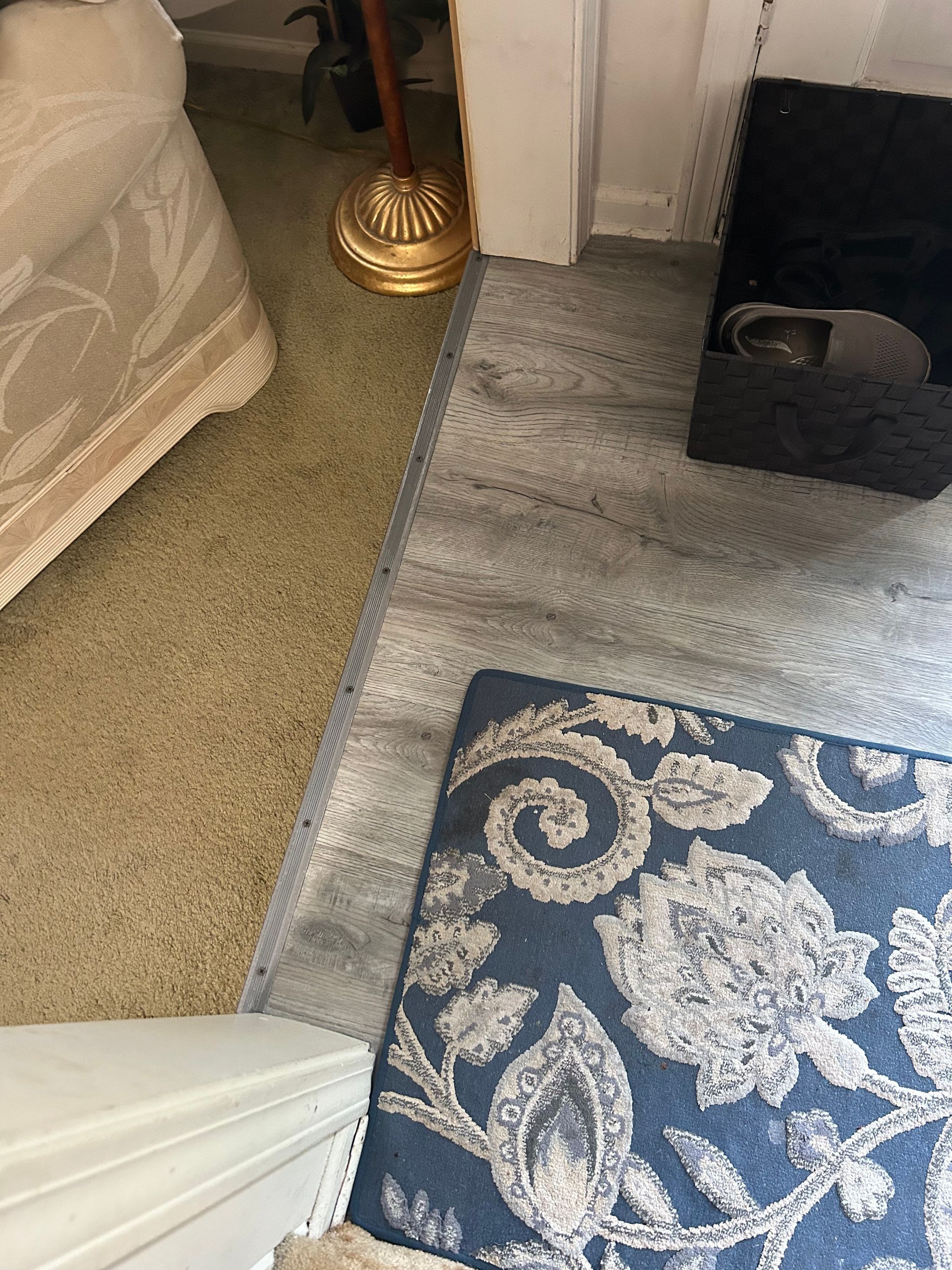 A blue and white rug is on the floor in a living room.