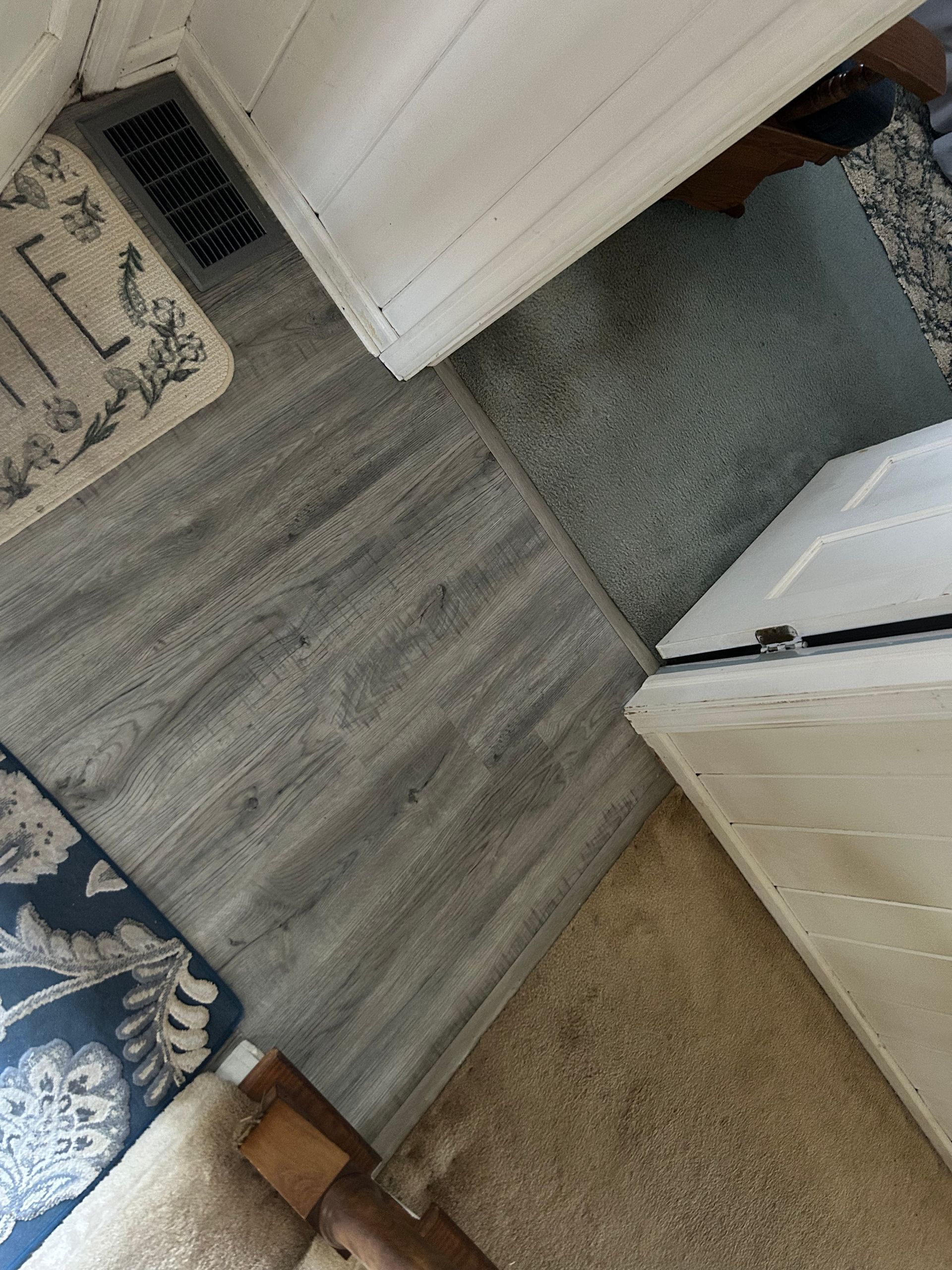 A room with a rug on the floor and a rug on the wall.