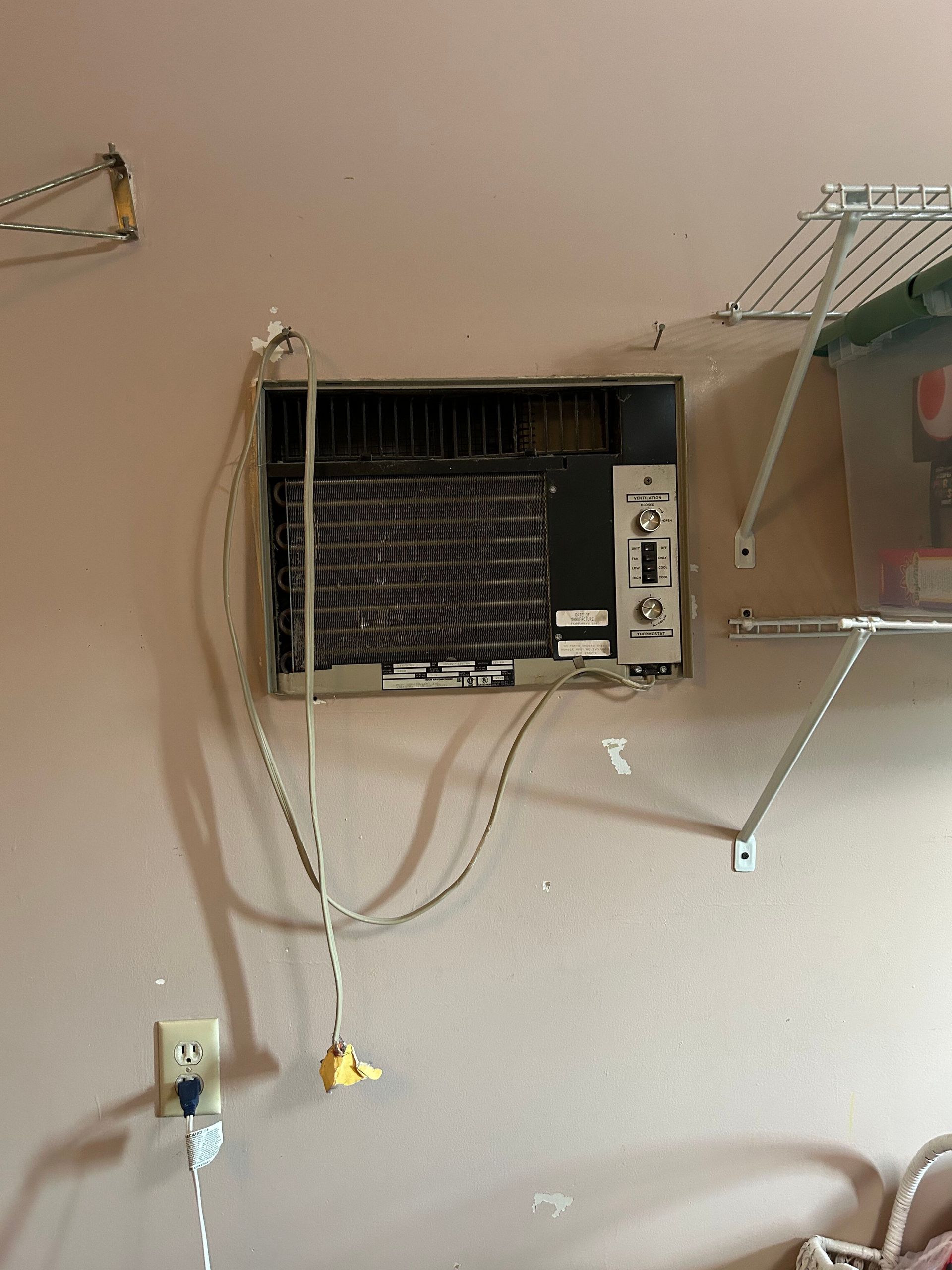 An air conditioner is hanging from the ceiling in a room.