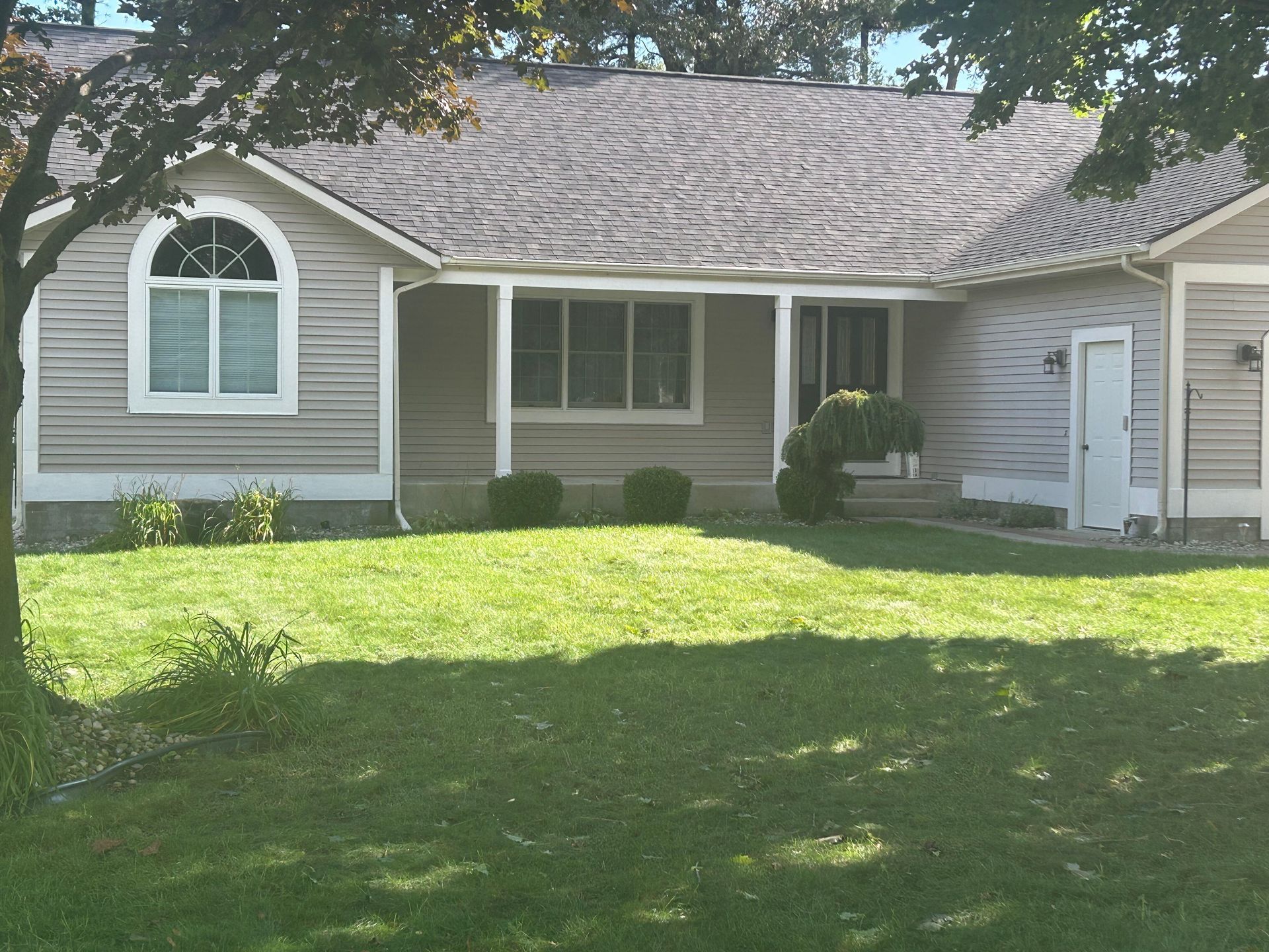 A house with a large lawn in front of it
