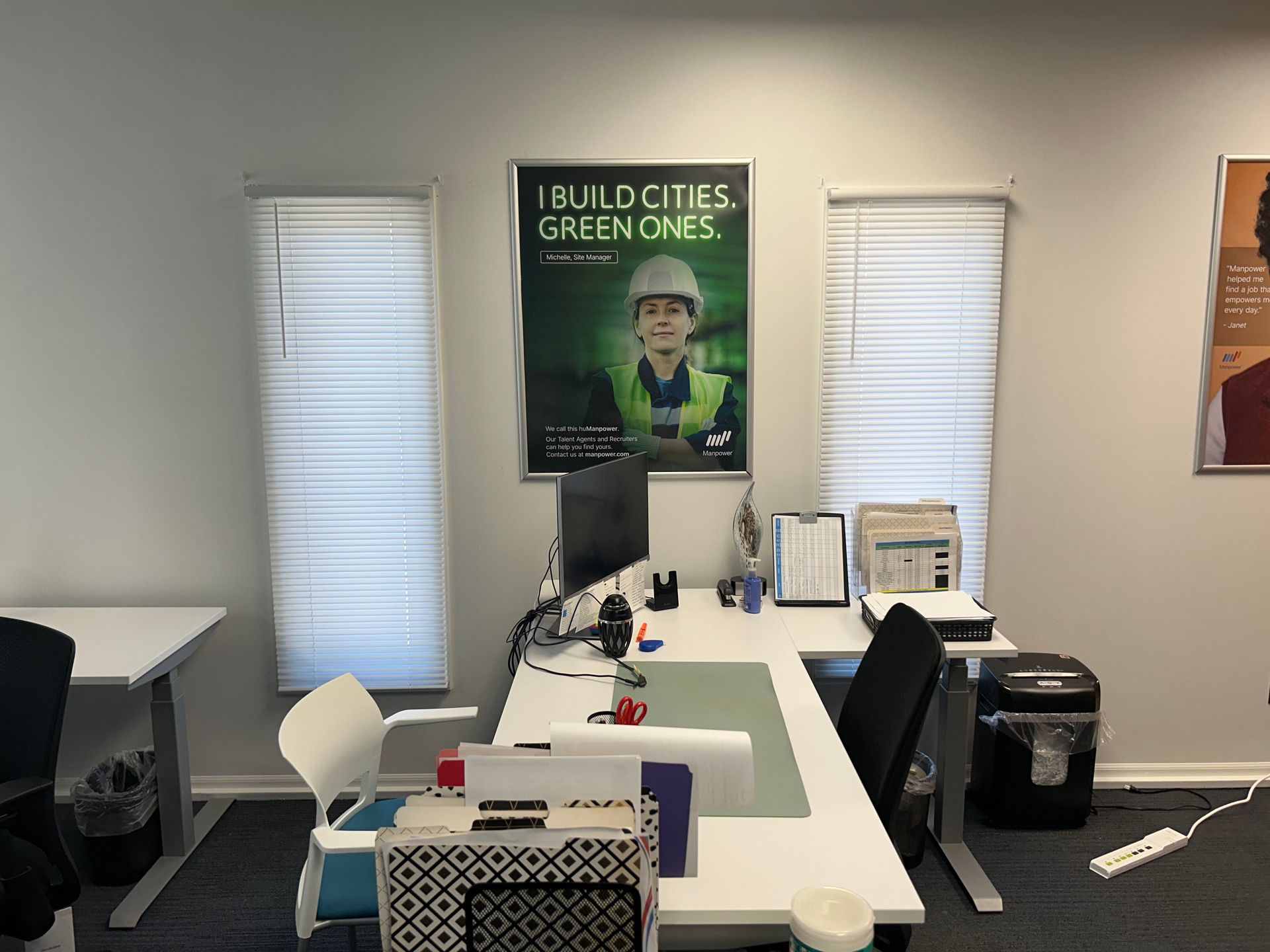 An office with a sign on the wall that says build cities green ones