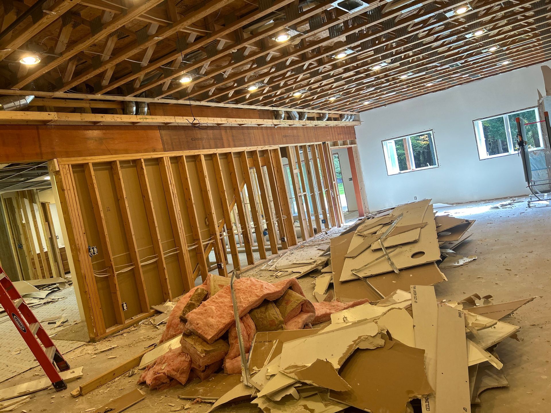 A room under construction with a pile of cardboard on the floor.