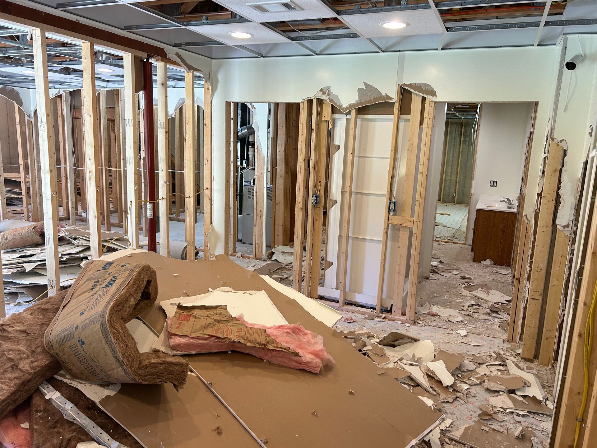 A room that is being remodeled with a lot of pieces of wood on the floor.