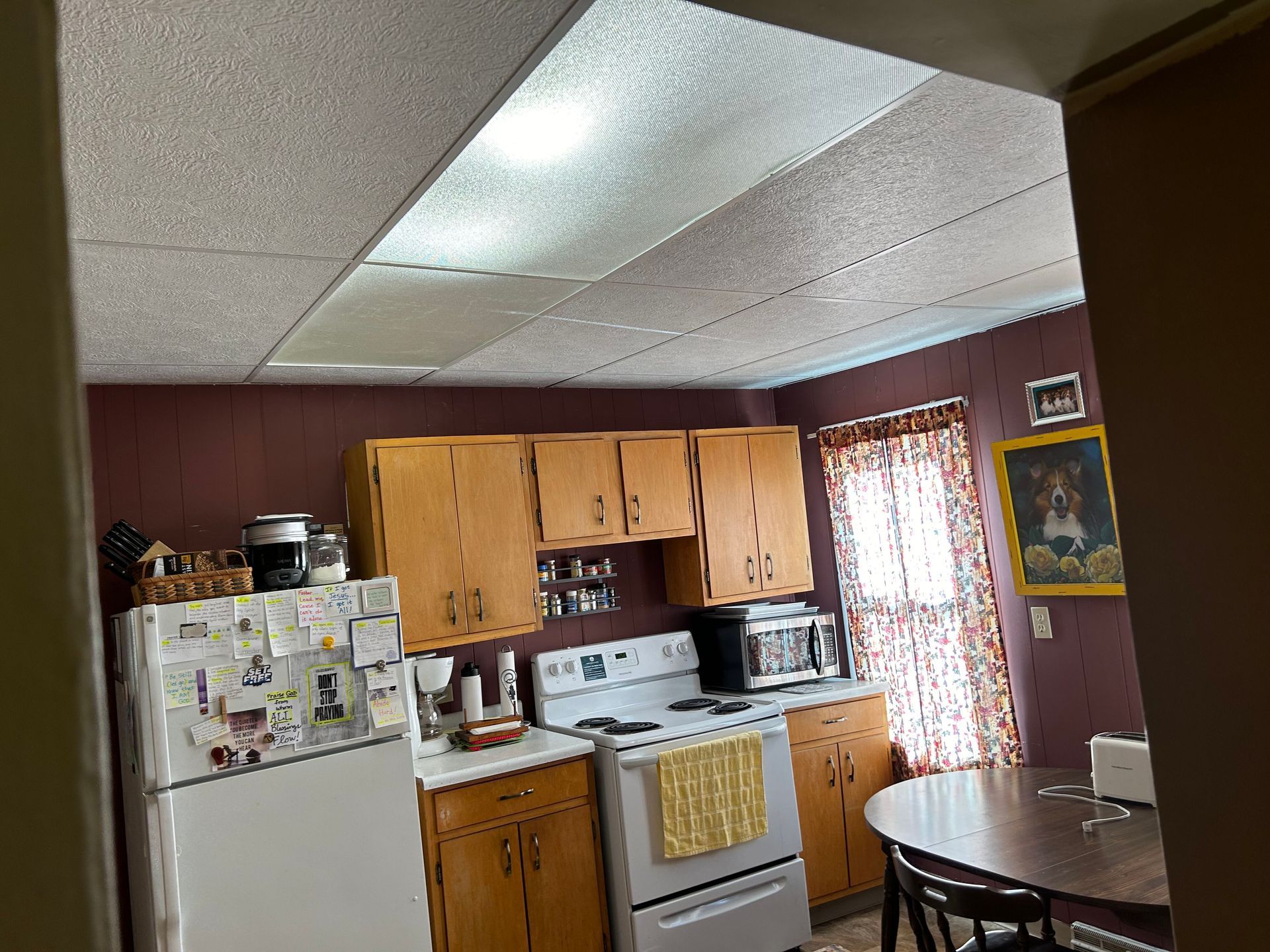 A kitchen with a table and chairs and a refrigerator