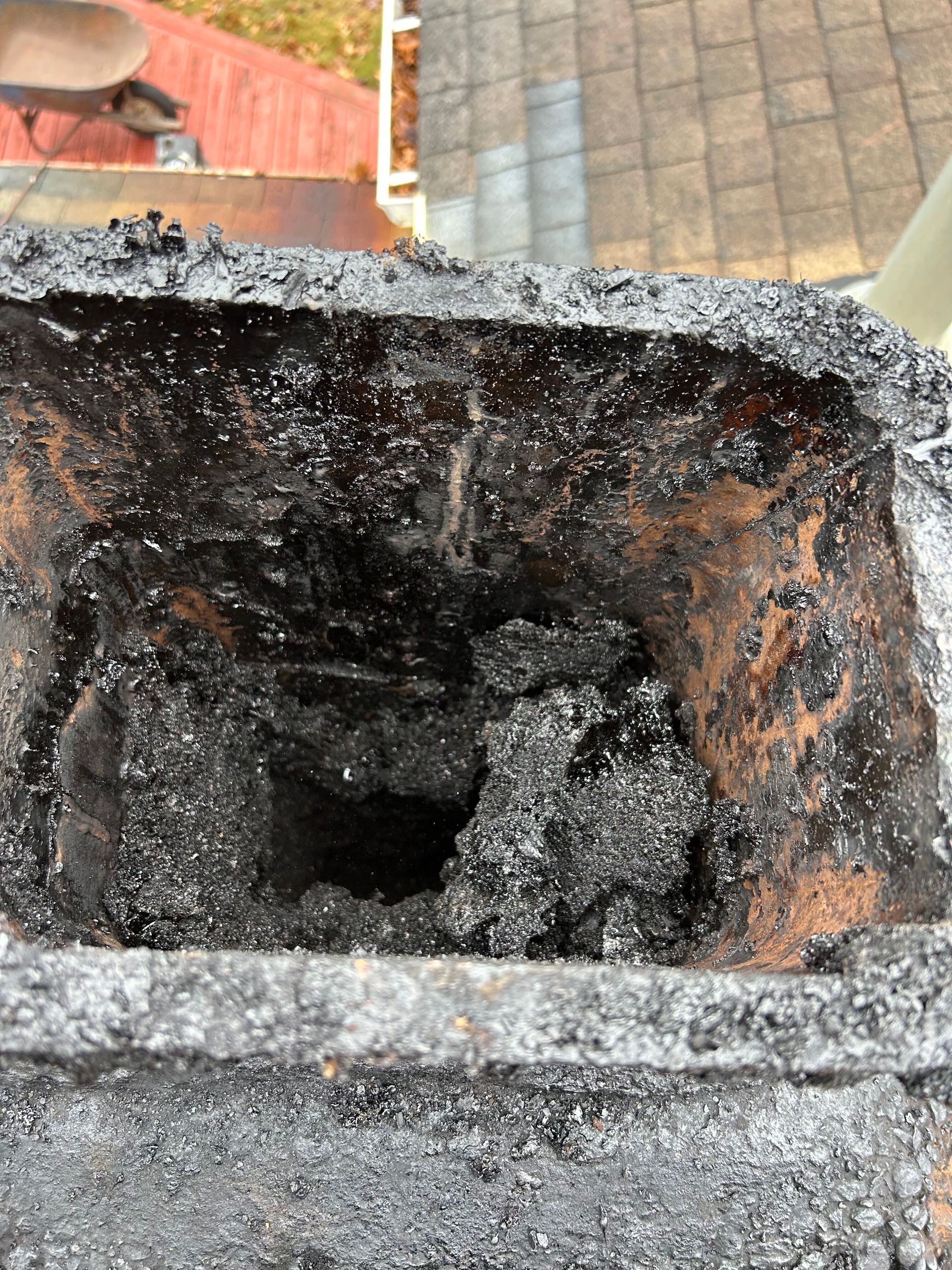 A close up of a chimney with a lot of ash coming out of it.