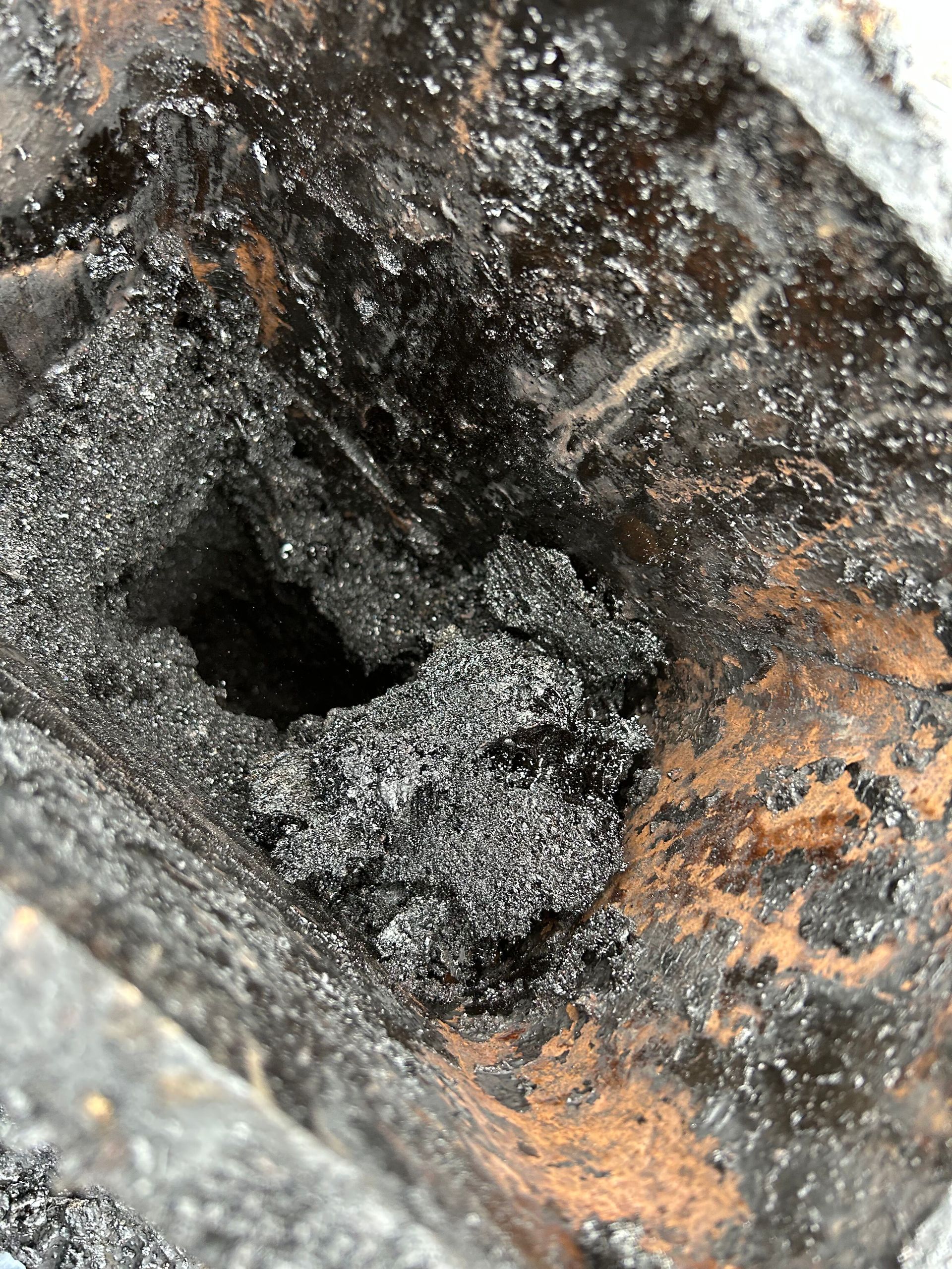 A close up of a hole in the ground with a lot of dirt in it.