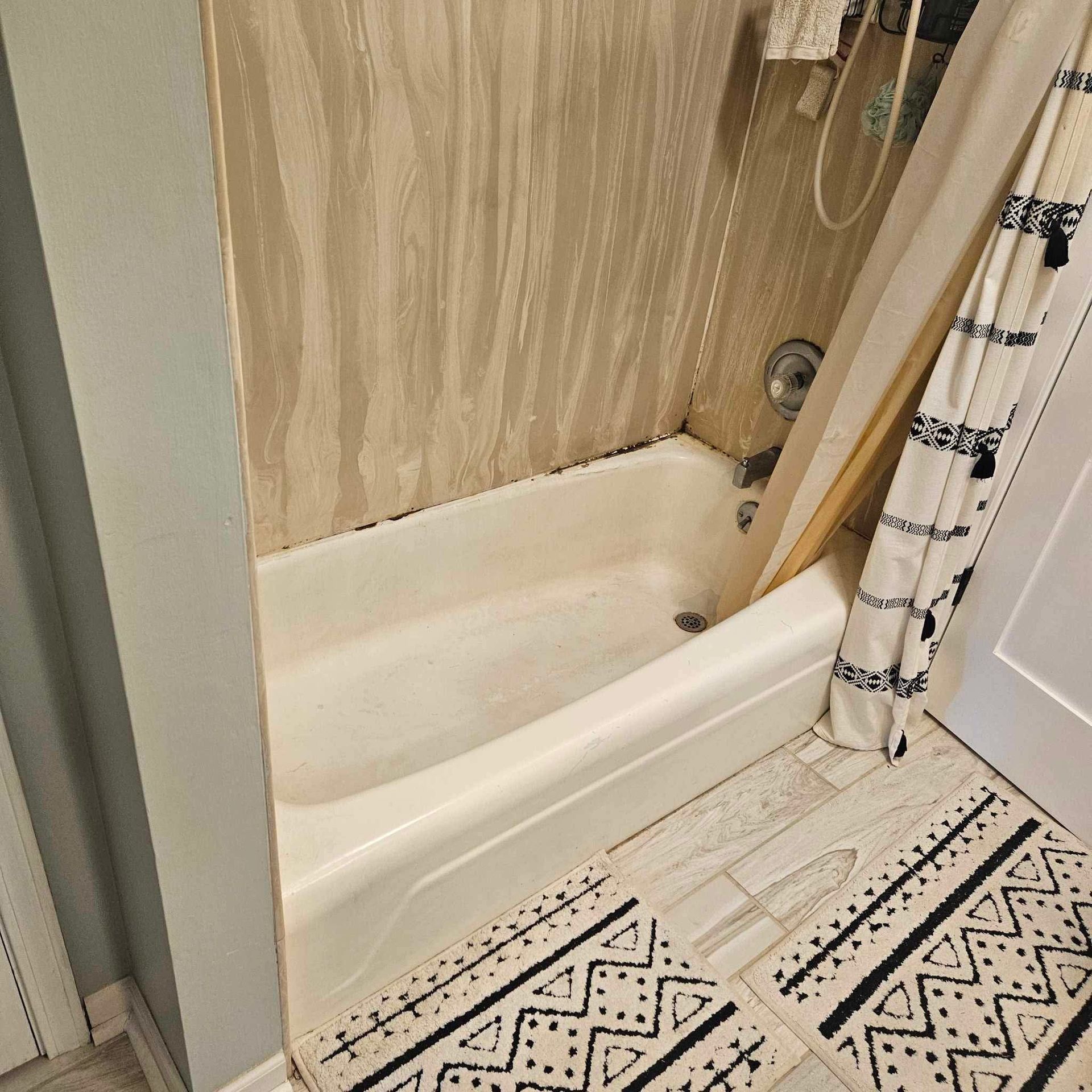 A bathroom with a bathtub and a shower curtain.