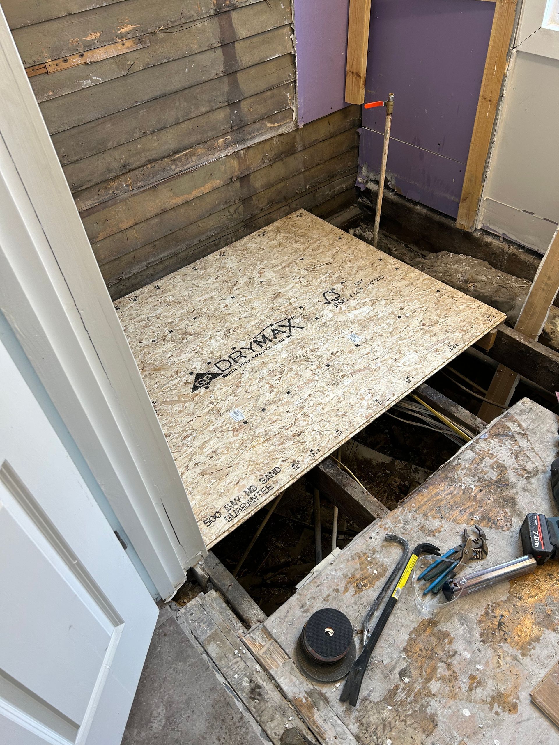 A piece of plywood is sitting on the floor of a room.