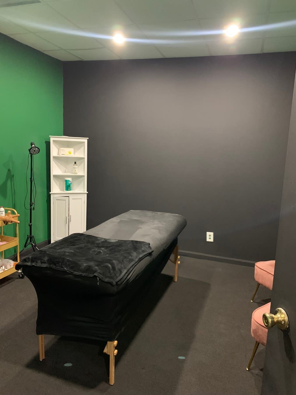 There is a massage table in the middle of the room.