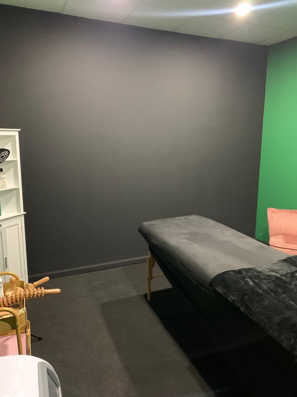 There is a massage table in the middle of the room.