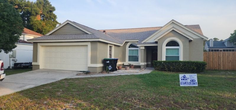 A house with a sign in front of it is for sale.