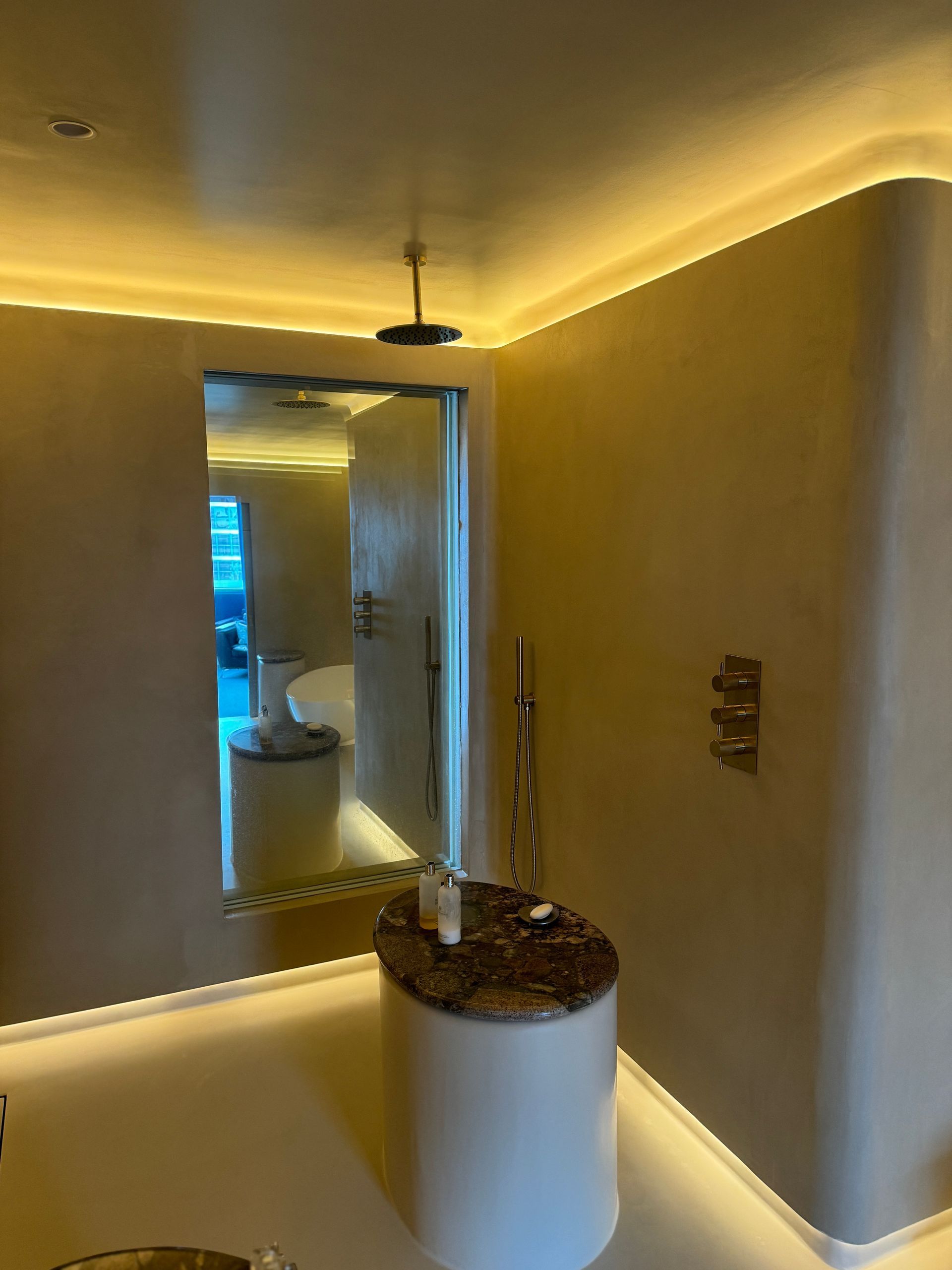 A bathroom with a sink , mirror and shower.