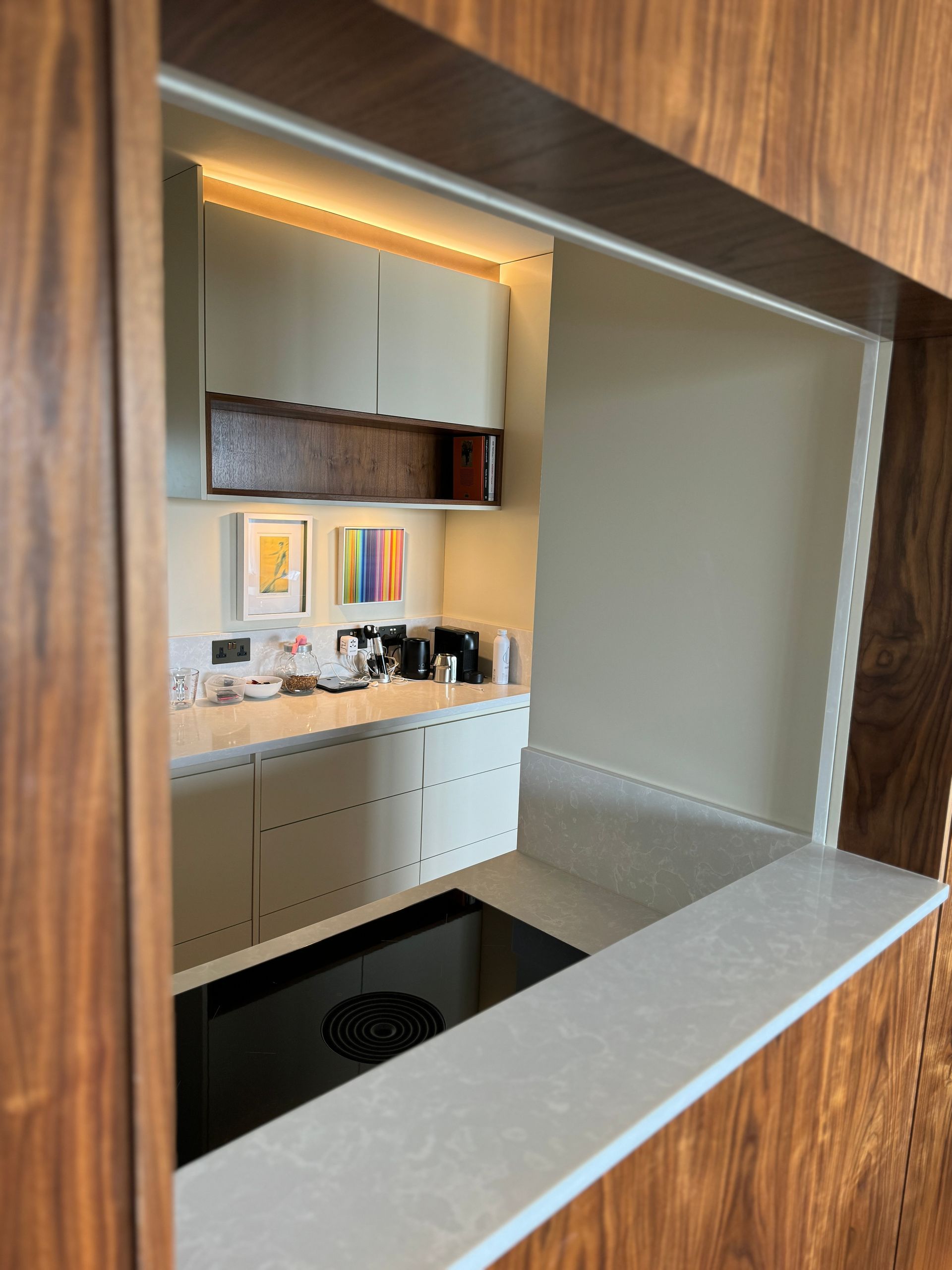 A kitchen with white cabinets and a black stove top oven