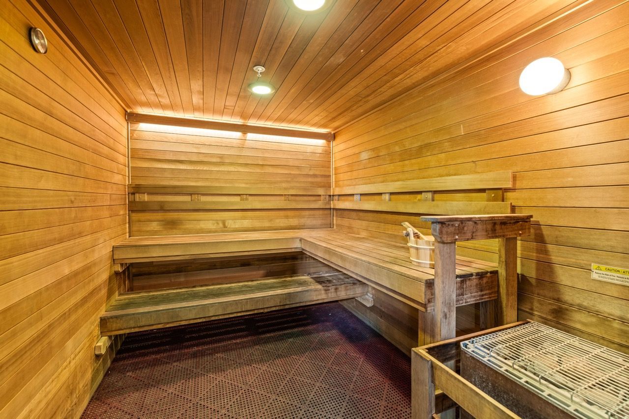 Wood-paneled indoor sauna with two-tier benches and a heater at Mountain Trail, offering apartments for rent in Flagstaff near NAU.