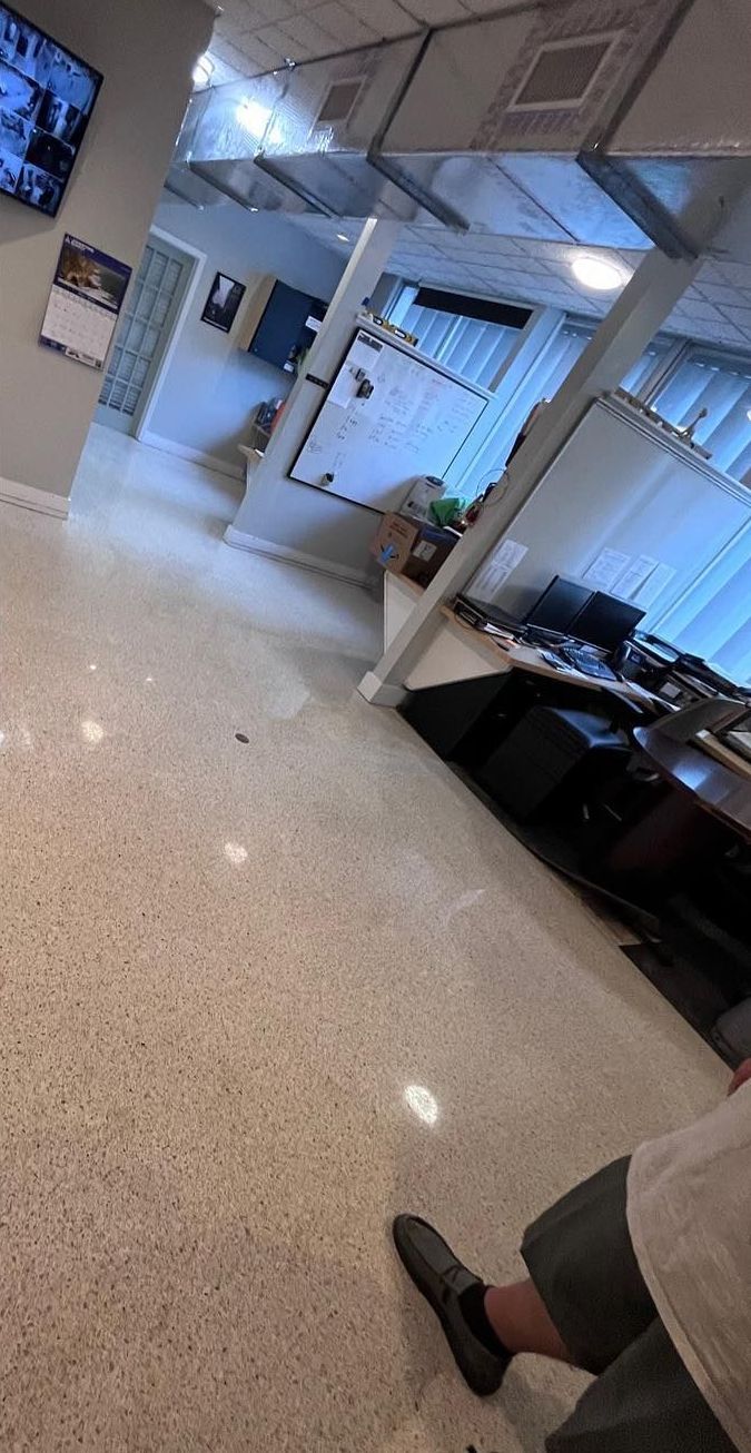 A person is standing in a room with a marble floor.