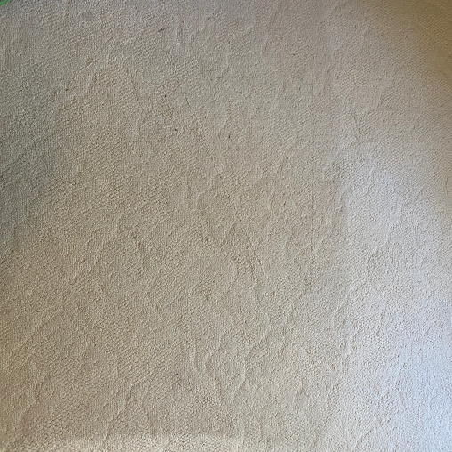 A close up of a white surface with a grainy texture.