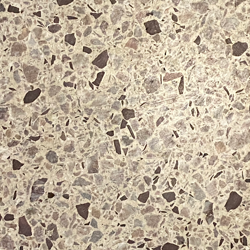 A close up of a tile with a lot of small rocks on it.