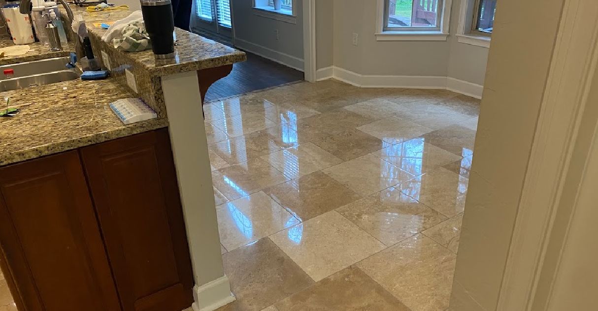 A kitchen with a marble floor and a granite counter top.
