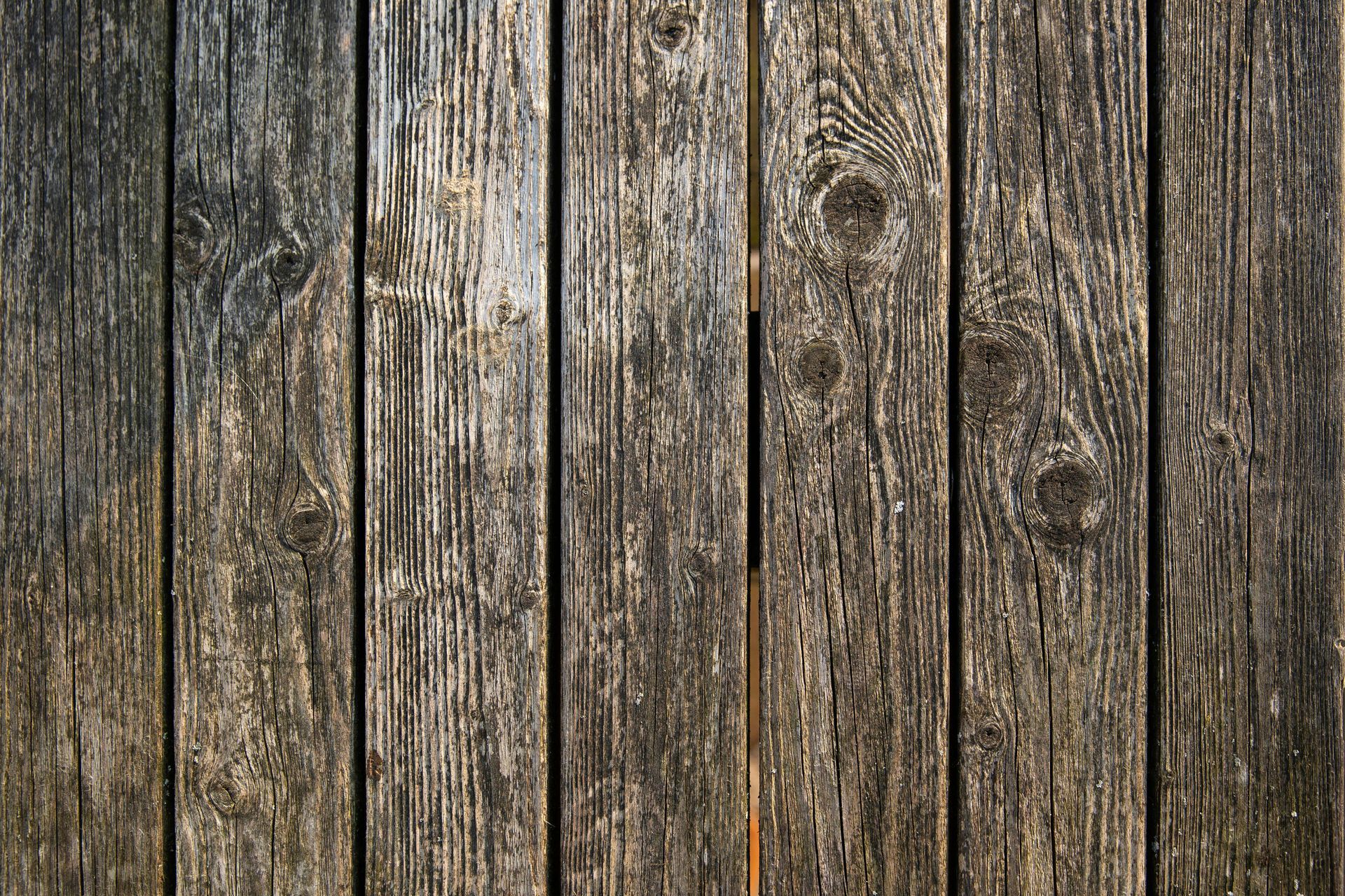 A close up of a wooden fence made of wooden planks.