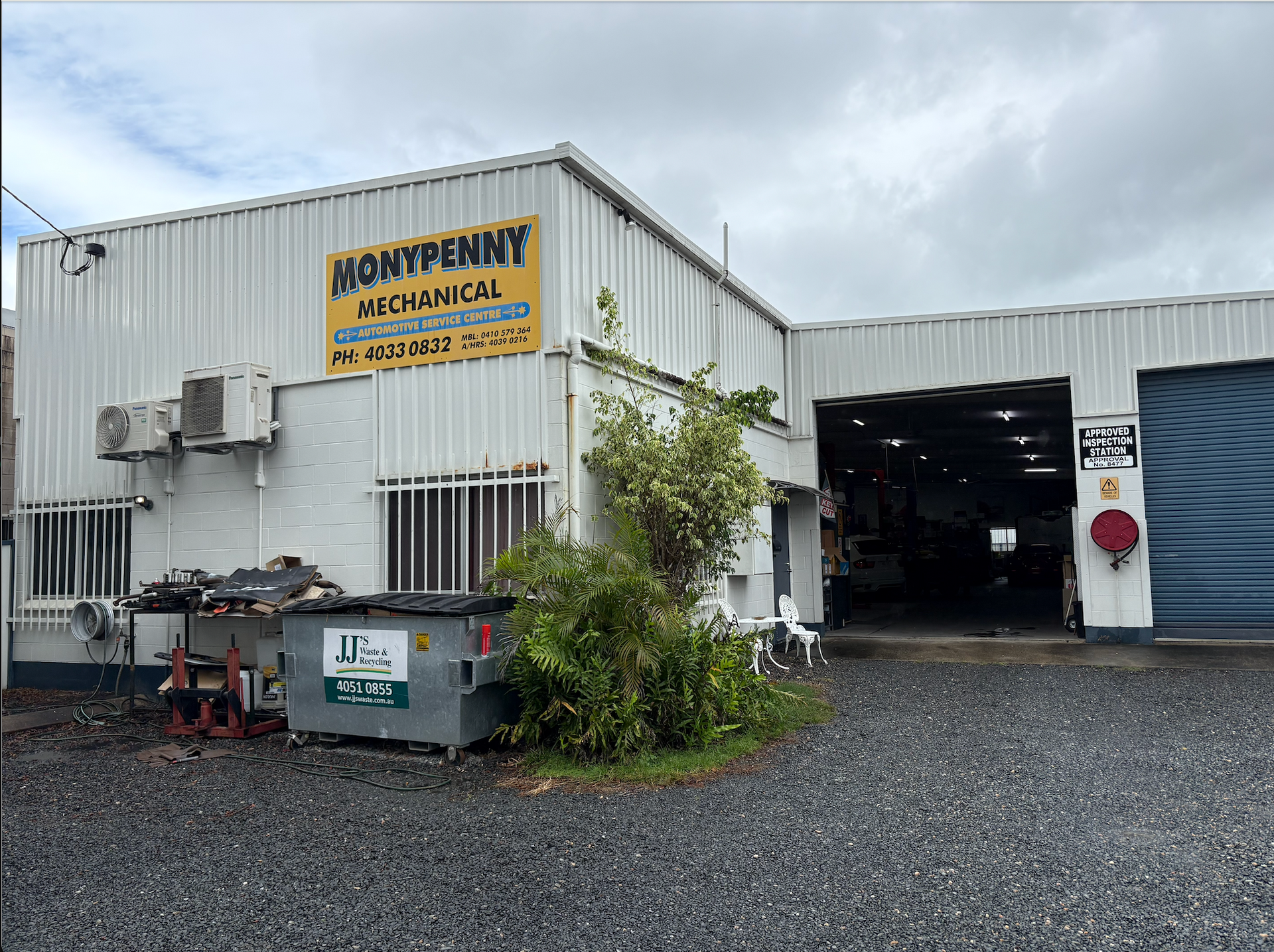 A Woman Is Writing on A Clipboard While a Man Works on A Car Engine — Monypenny Mechanical in Edmonton, QLD
