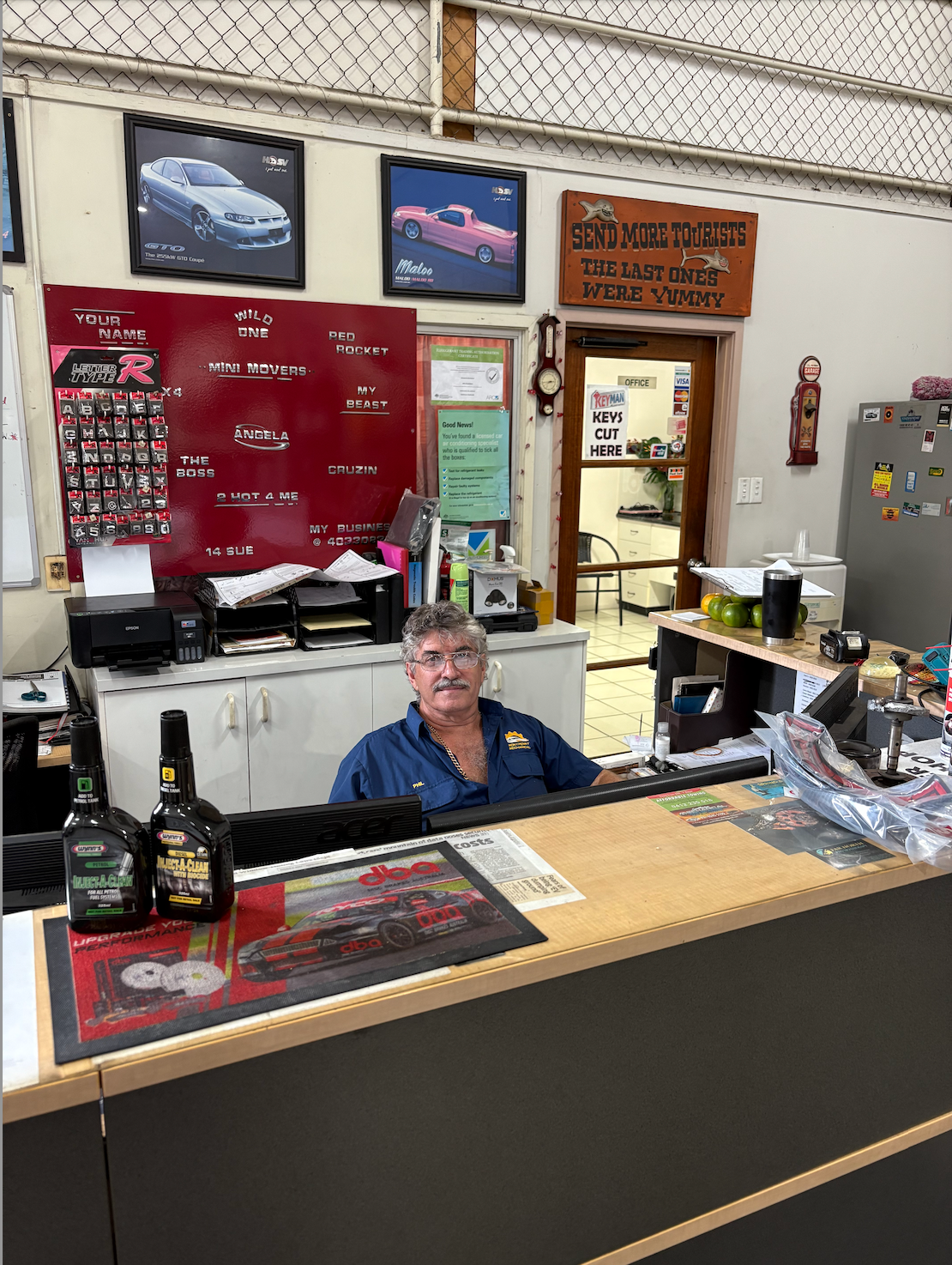 A Man Sitting Behind a Desk — Monypenny Mechanical in Edmonton, QLD