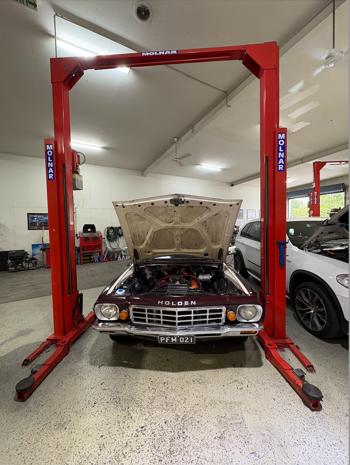 A Car with it's Bonet Up Getting Worked on — Monypenny Mechanical in Bungalow, QLD