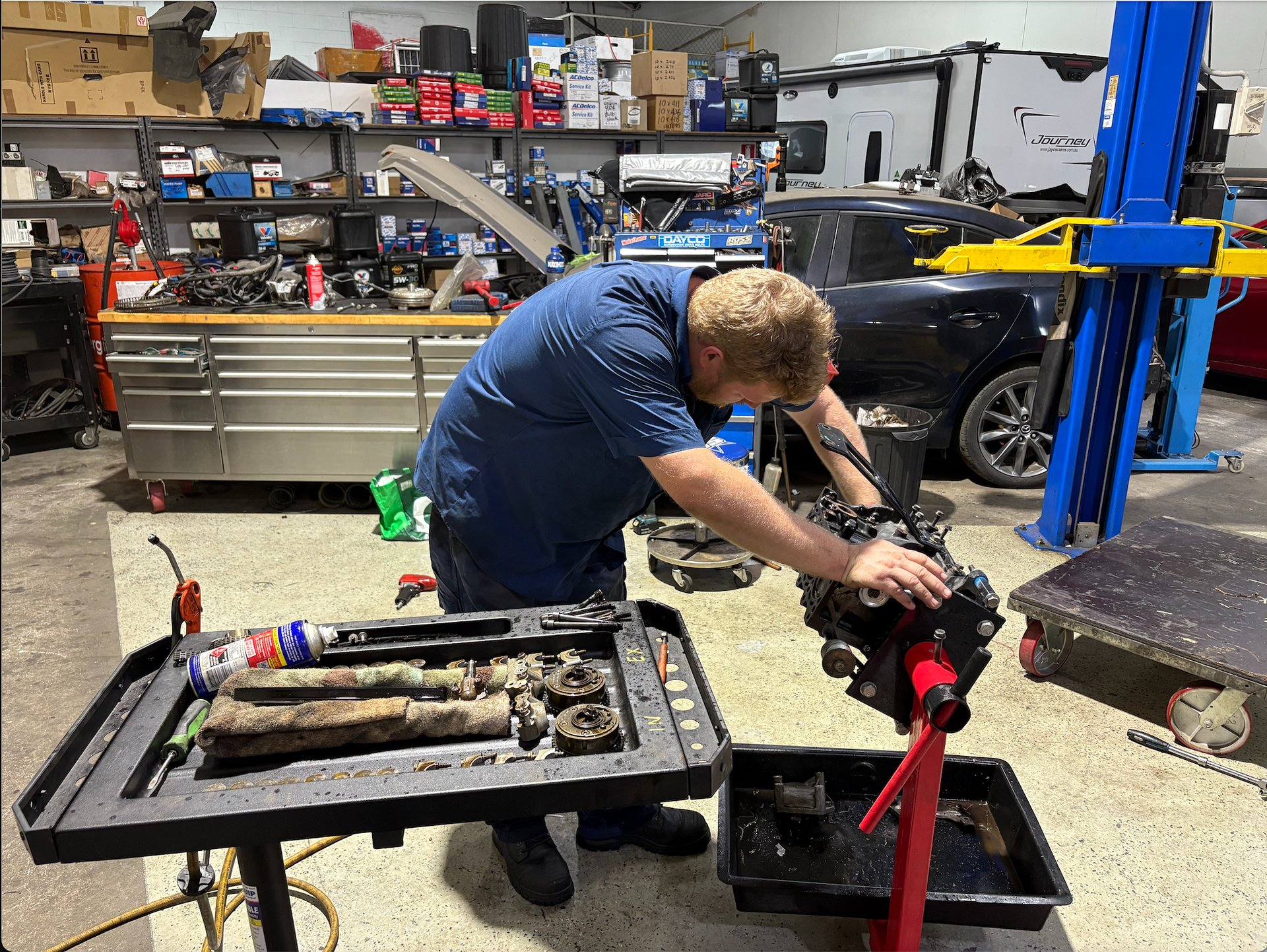 A Man Working on A Car Engine — Monypenny Mechanical in Bungalow, QLD