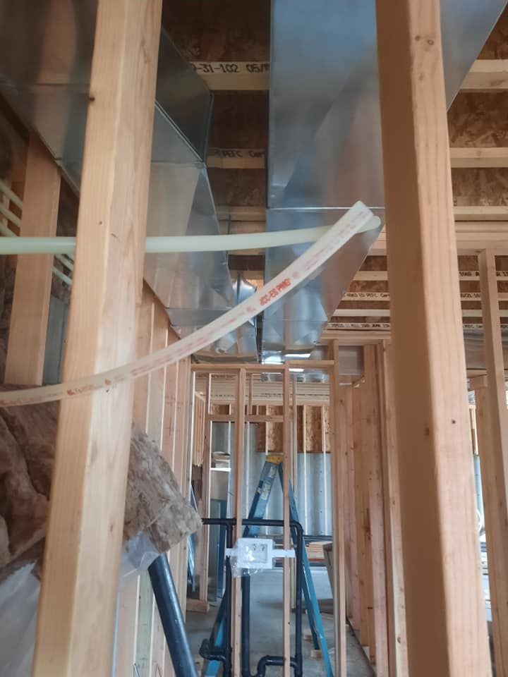 A ladder is sitting in the middle of a building under construction.